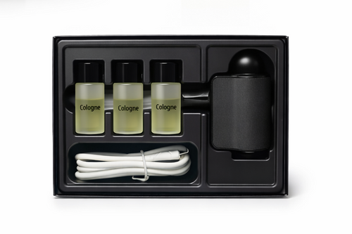 Set of cologne bottles and a diffuser in a black packaging box on a white background